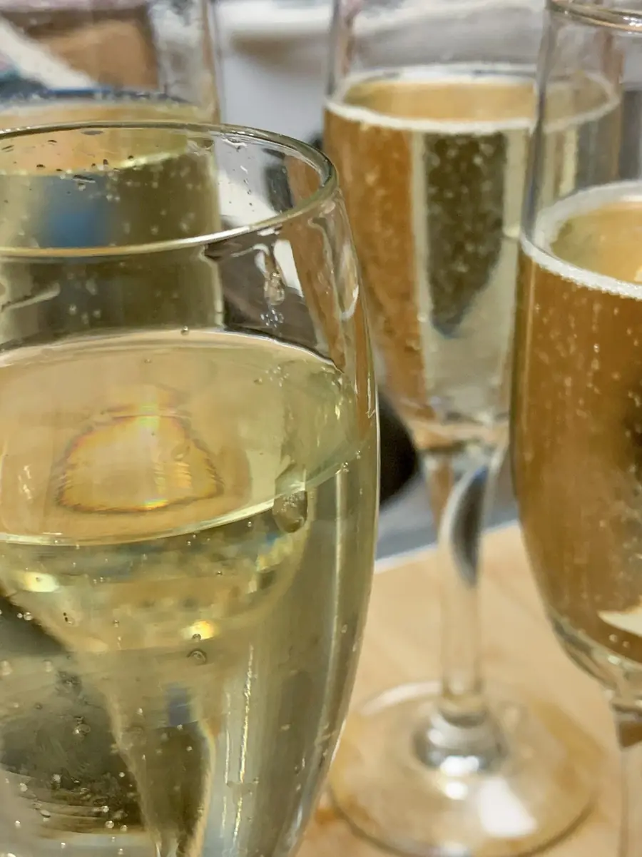 Two champagne flutes catching the light